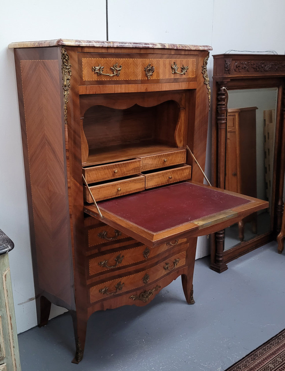 Walnut Louis XV style marble top abbattant with beautiful parquetry inlay and ormolu mounts. It has plenty of storage space with four large drawers and four smaller internal drawers. Beautiful drop down desk with a leather insert. In very good original detailed condition.