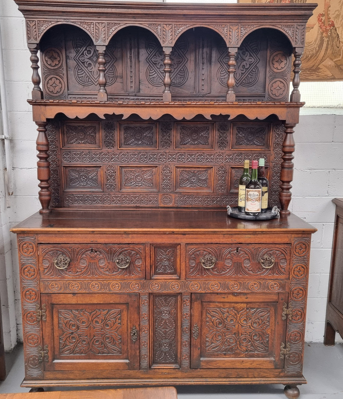 Impressively carved 18th Century English Oak kitchen dresser in 17th Century Jacobean style. It is in good original detailed condition and has been sourced from France.