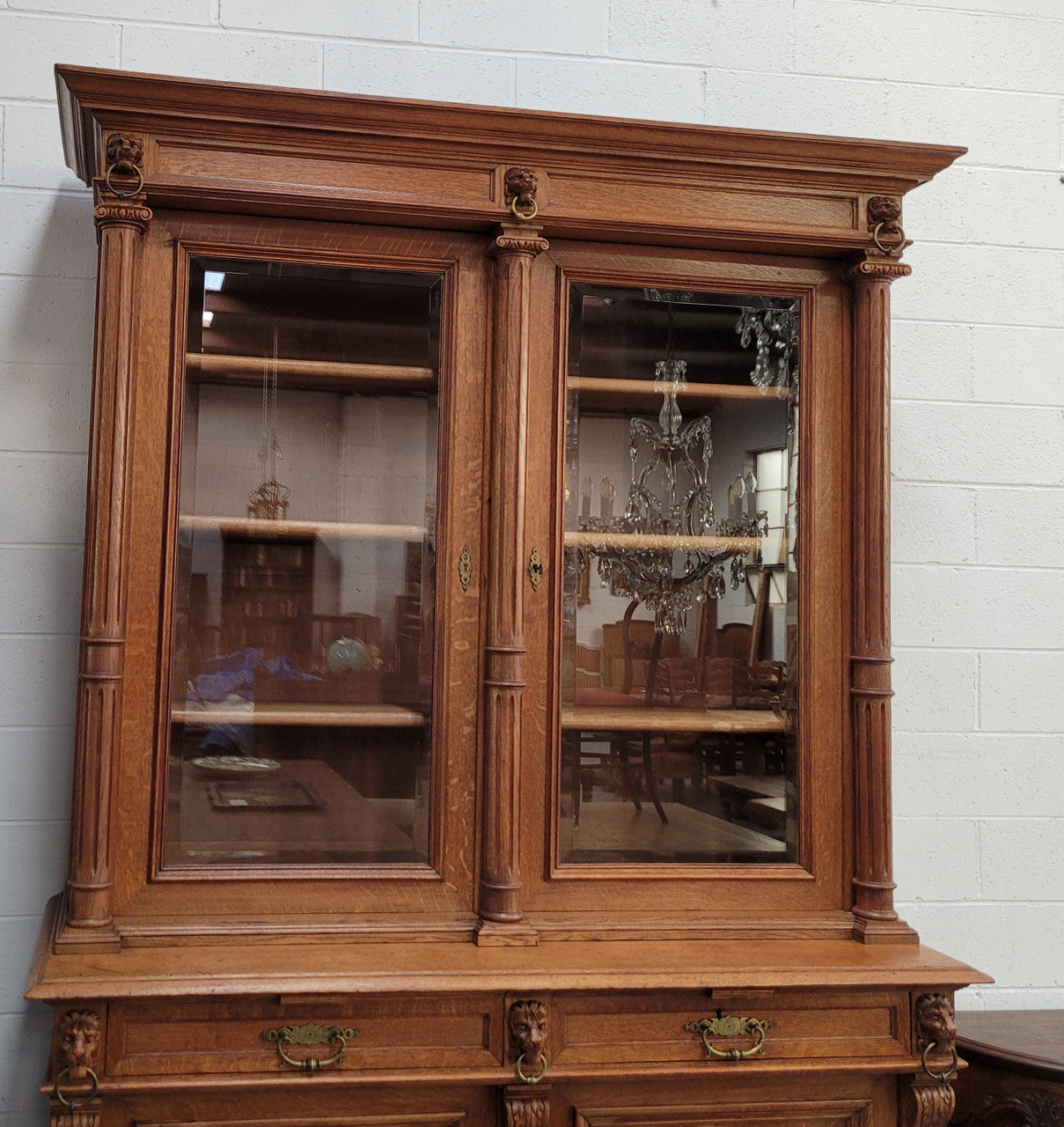 Amazing French 19th Century Oak two-door bookcase. Amazing detailed carvings throughout and plenty of storage space with three adjustable shelves at the top, two drawers, and a further shelf at the bottom. Also has two pull out reading slides giving you a large area to view your books on. In very good original detailed condition.
