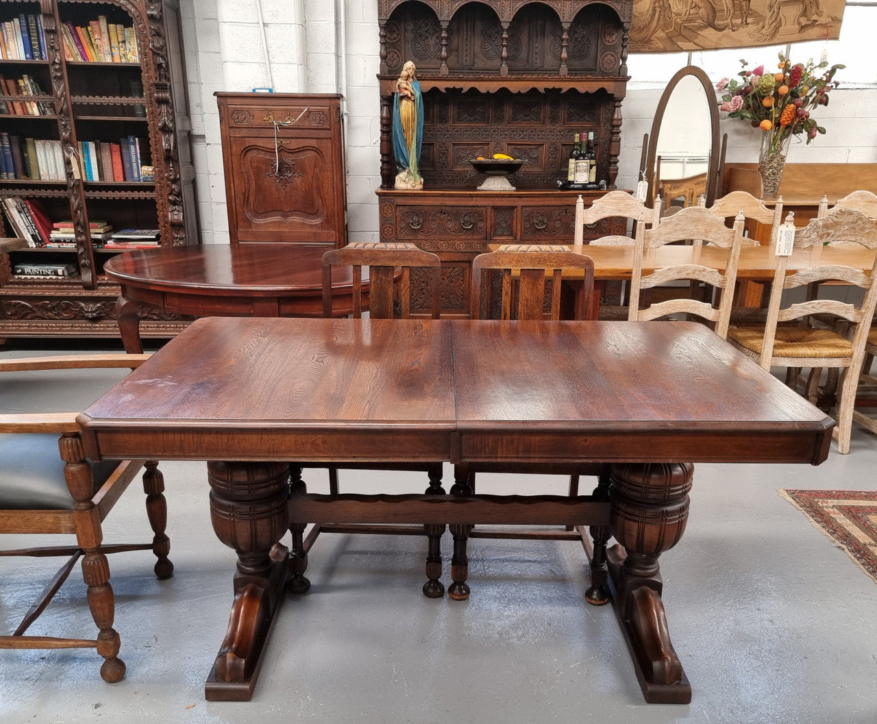 Tudor oak dining setting consisting of draw leaf extension table, 4 dining chairs and 2 carver chairs. Upholstery in excellent condition. Circa: 1930’s. The table, chair and carver chairs are in good original detailed condition.