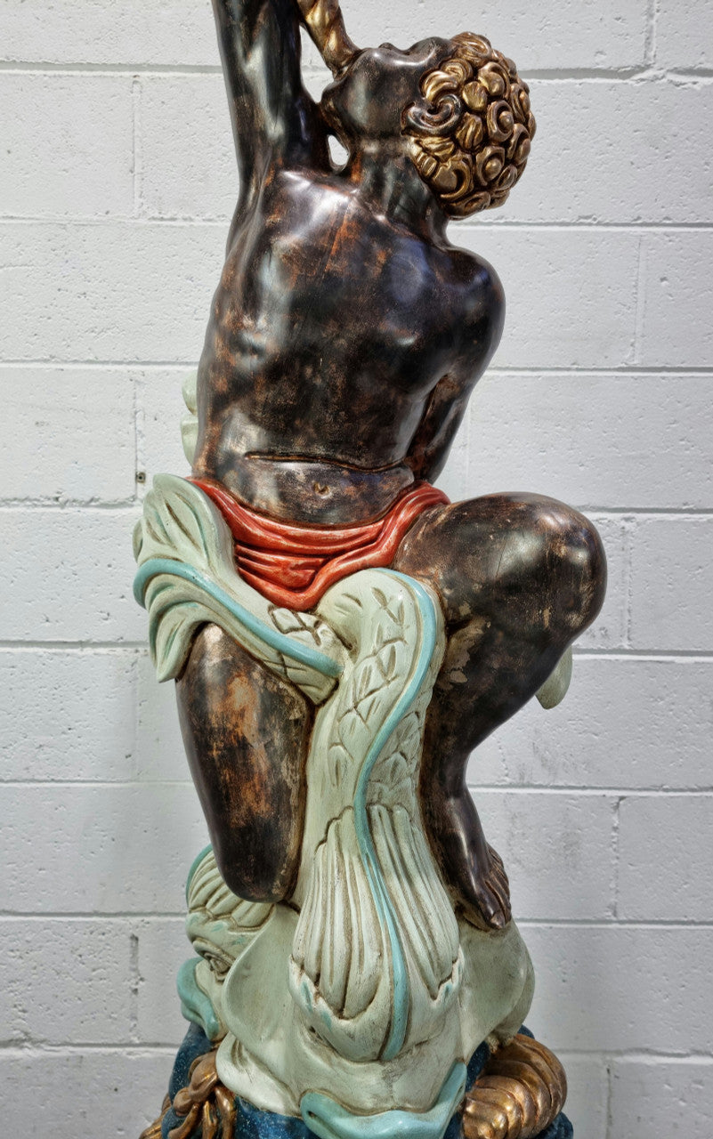19th Century Italian Wooden Blackamoor lamp sourced in France. Made from carved wood painted & gilded. Amazing detail of a man playing a horn that then turns into a chandelier while riding a mythological sea serpent It has been fully rewired to Australian standards.