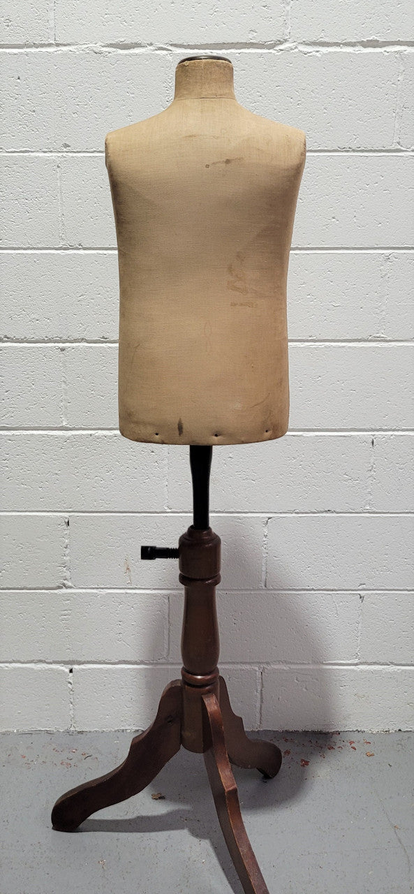 Vintage fabric covered child mannequin on adjustable wooden base. In good original condition.