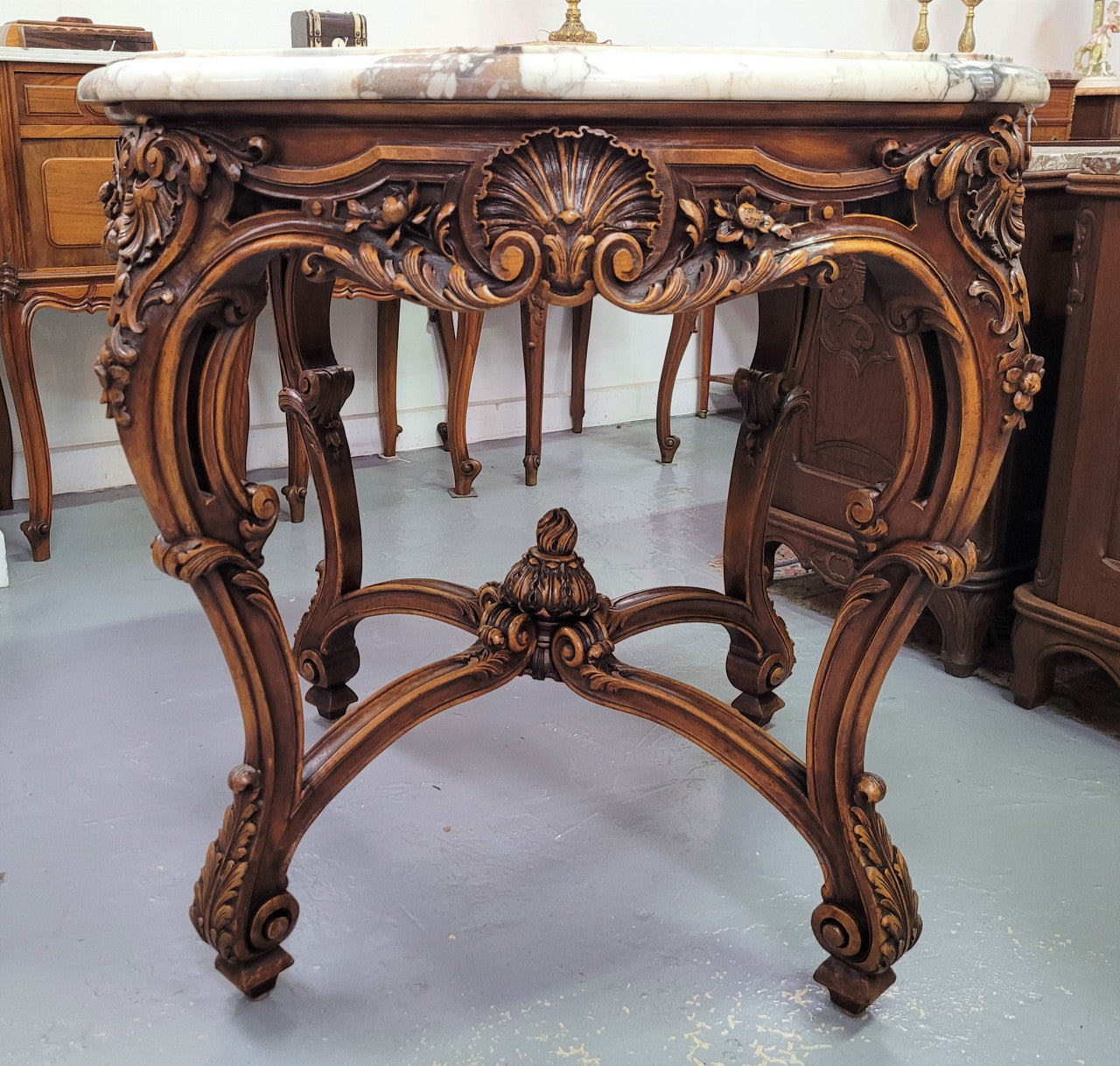 French Walnut Louis XV style round marble top centre table. It has amazing eye-catching marble, ornate detailed carvings and a beautifully carved undercarriage. In good original detailed condition.
