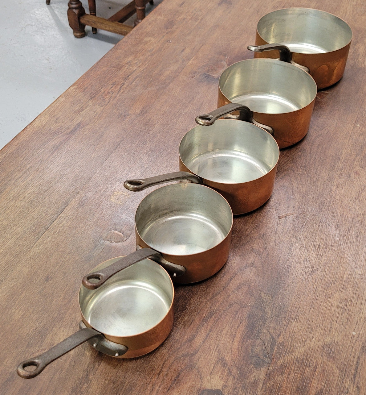 Set of five copper sauce pans with foundry stamp. They have been sourced from France and are in good original detailed condition.