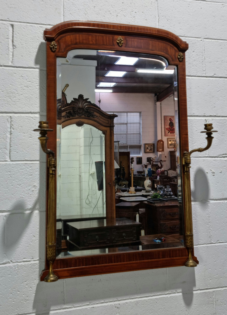 Decorative late 19th Century mahogany French wall mirror with brass swivel candle holders and brass detail. In good original detailed condition.