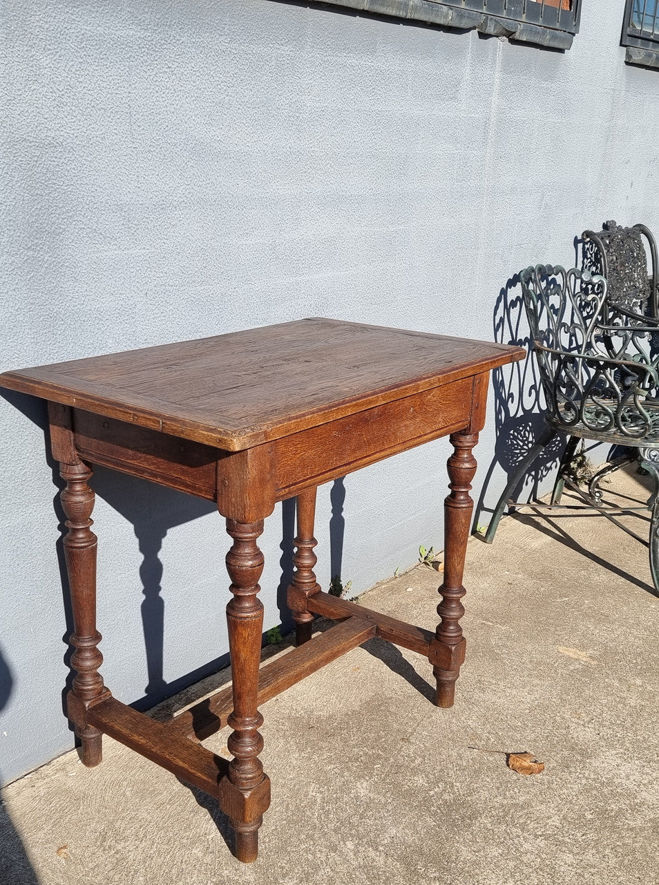 Lovely Oak Tudor style rope edge sideboard with leadlight centre door, three drawers and two solid cupboards. In good original condition.