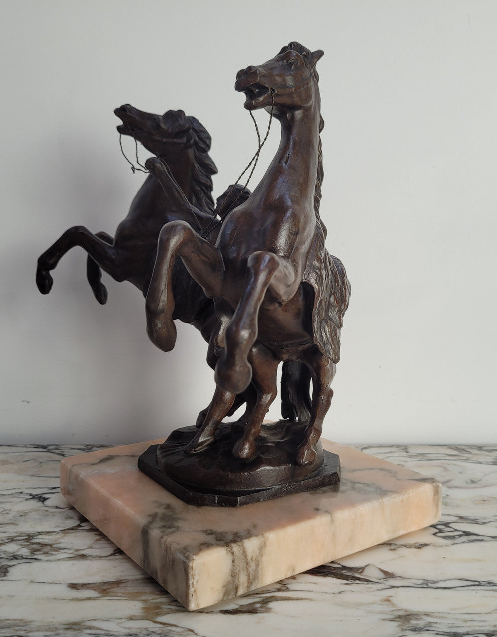 French Art Deco cold painted bronze metal marley horses style statue on a marble base. It is in good condition.