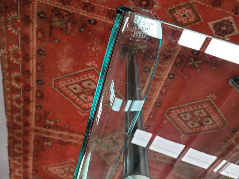 Striking and distinctive Vintage FIAM Italia Designer curved edge glass desk. FIAM was founded in 1973 by Vittorio Livio and has become synonymous with glass culture in Italy and the World. FIAM is still manufacturing today, in collaboration with various Designers, and has won numerous awards and is represented in various international museums. 
Condition: Evidence of use with minor scratches to the surface and a small chip that has been repaired. Overall, in very good condition with one repaired chip to t