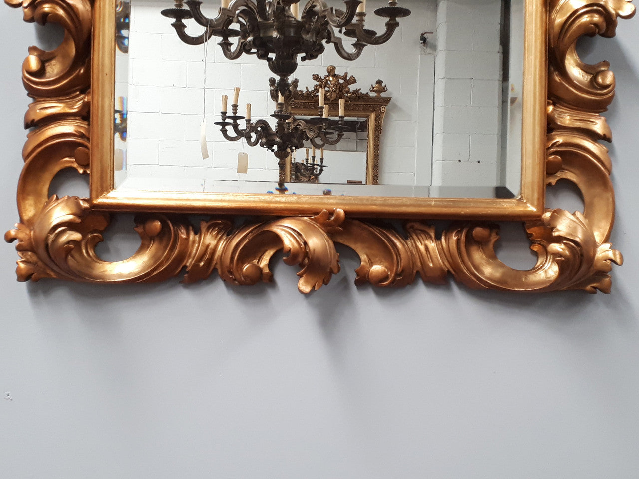 Early 20th Century French Rococo style gilt bevelled wall mirror. It has been sourced from France and is in good original condition. Circa 1920