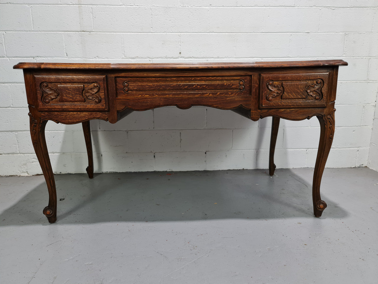 Attractive large Louis XV style Oak faux partners desk. Nicely carved details with three large functioning drawers, and three faux drawers at the back. In good original detailed condition.