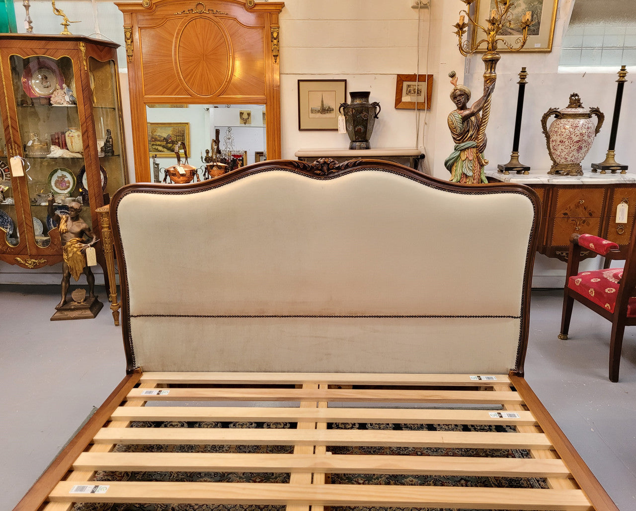 French Louis XV style queen size upholstered bed. Upholstery is in good condition and bed is complete with custom made slats. Just place your mattress on top.