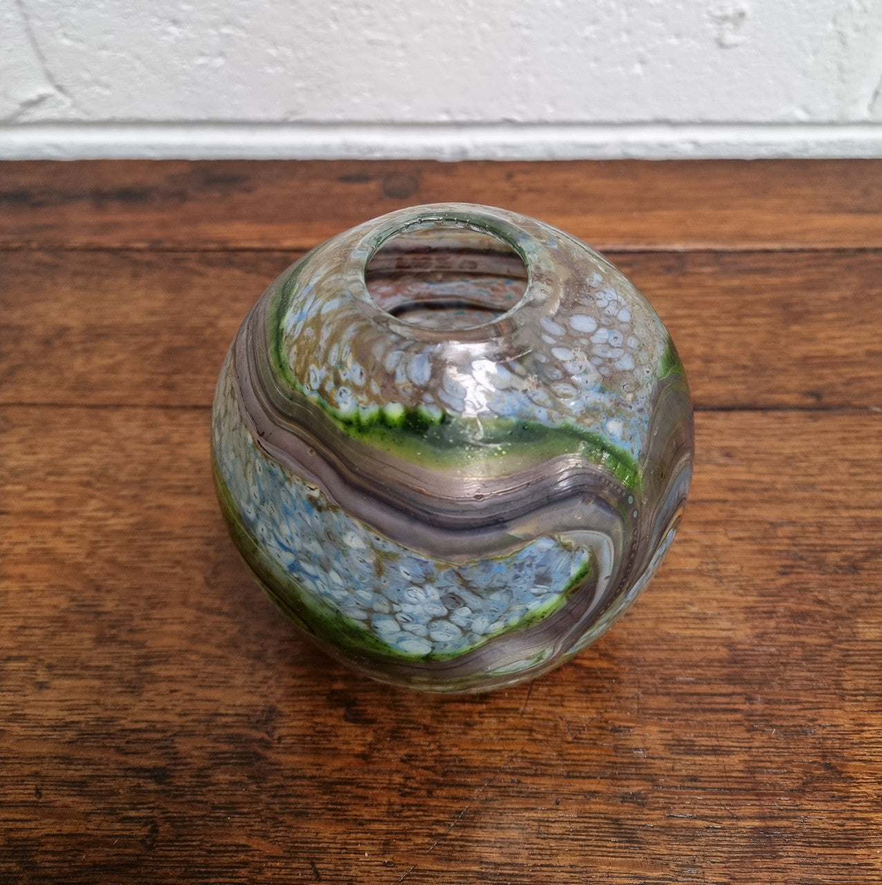 A stunning gallery quality Australian studio art glass vase masterfully handcrafted and signed by the renowned glass artist Don Wreford in 1984. Don Wreford was one of Australia's leading glass blowers and an artist of international renown. Don worked from his studio in Daylesford, Victoria, where he created unique and artistic pieces known for their stunning forms and rich color combinations. Don's work is exhibited in leading galleries and features in prominent private and public collections around the wo