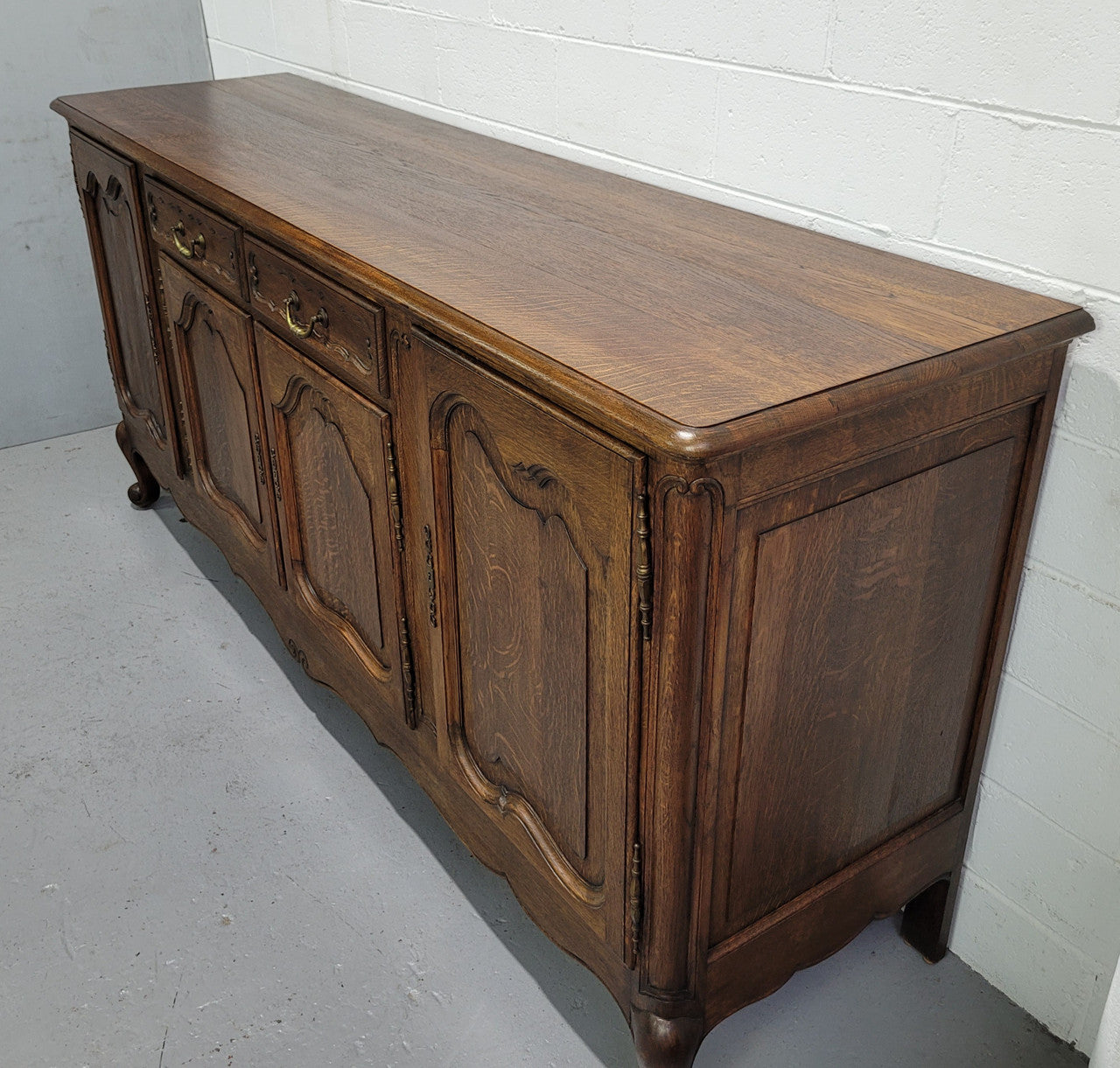 Late 19th Century French carved Oak Louis XV style four drawer sideboard. Plenty of storage space with four cupboards and two drawers. It is in good original detailed condition with all locks functioning with keys.