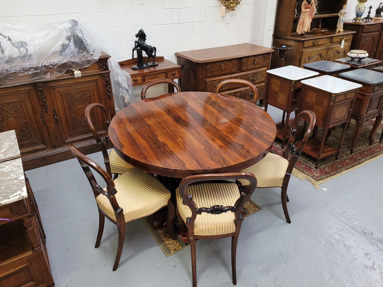 William IV Rosewood tilt top round table with six Rosewood chairs. It has been sourced from locally and is in good original detailed condition.