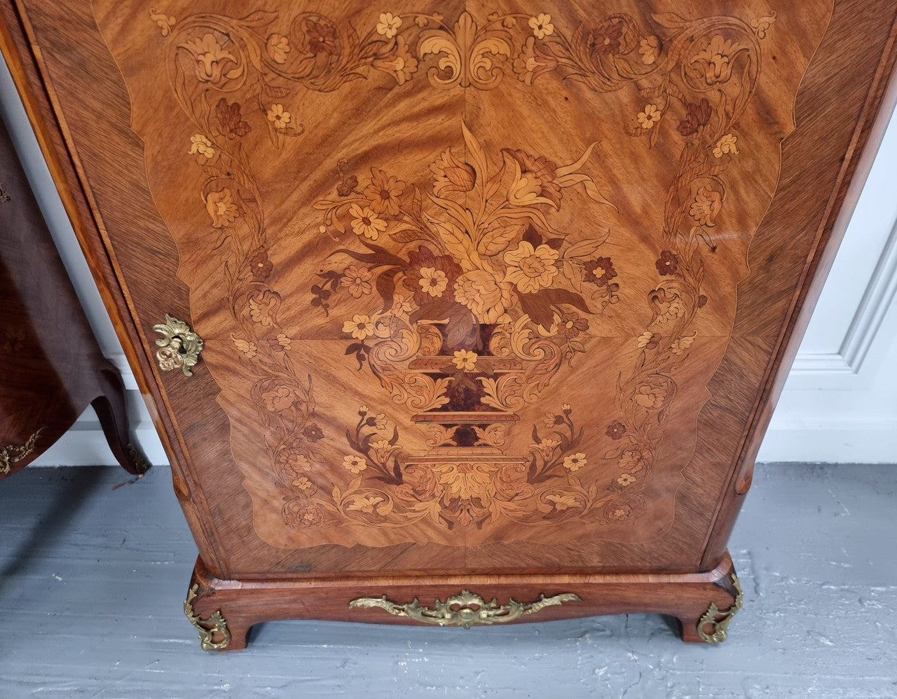 Elegant French transitional style Walnut & Kingwood Salon cabinet. It has beautiful marquetry inlay, a marble top and decorative ormolu mounts. Sourced From France and is in good original detailed condition.