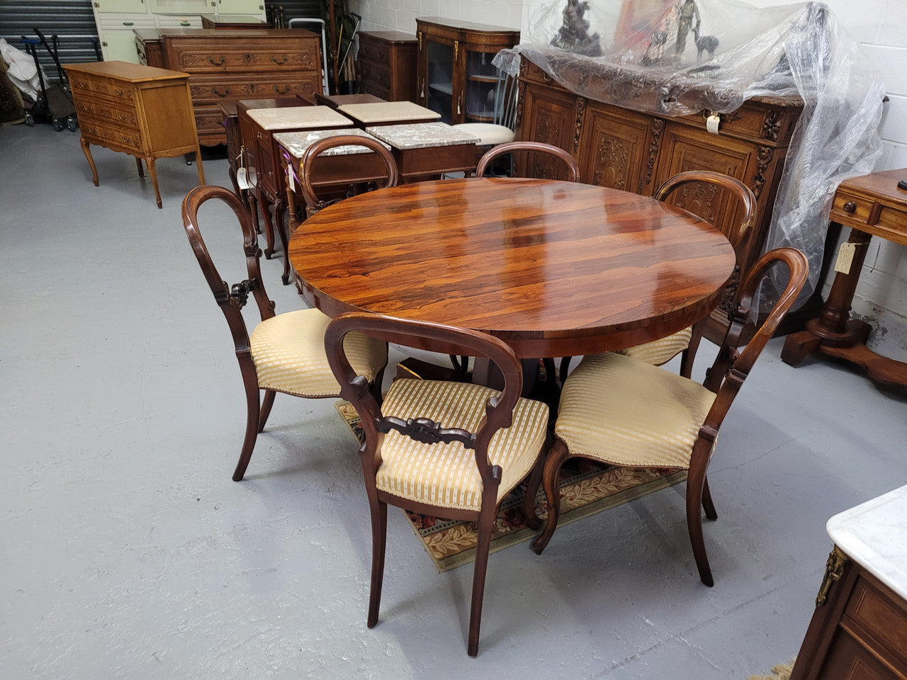 William IV Rosewood tilt top round table with six Rosewood chairs. It has been sourced from locally and is in good original detailed condition.