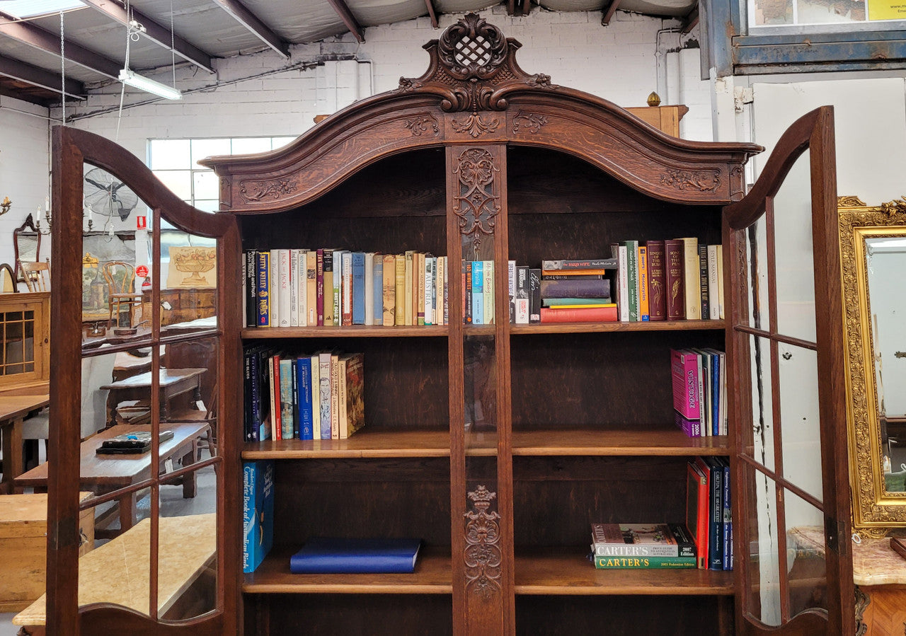Substantial French Oak Louis 15th Style large two door bookcase. Adjustable shelves and very decorative carving. In good original detailed condition.