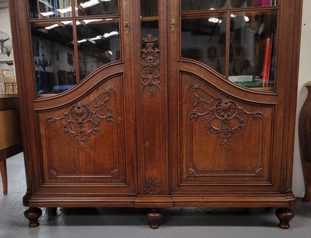 Substantial French Oak Louis 15th Style large two door bookcase. Adjustable shelves and very decorative carving. In good original detailed condition.