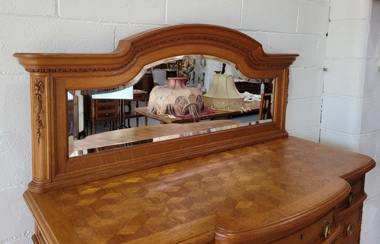 Beautiful French Oak Louis XVI Style nicely carved sideboard with a lovely parquetry top and mirror. It has five drawers and three cupboards for all your storage needs. In good original detailed condition.