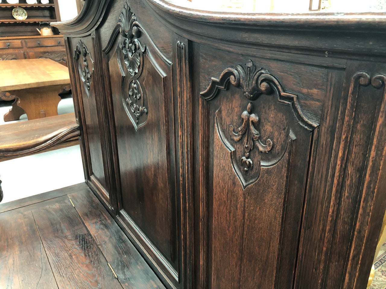 Beautifully carved French Oak hall seat with a lift up lid and storage space inside. In good original detailed condition.