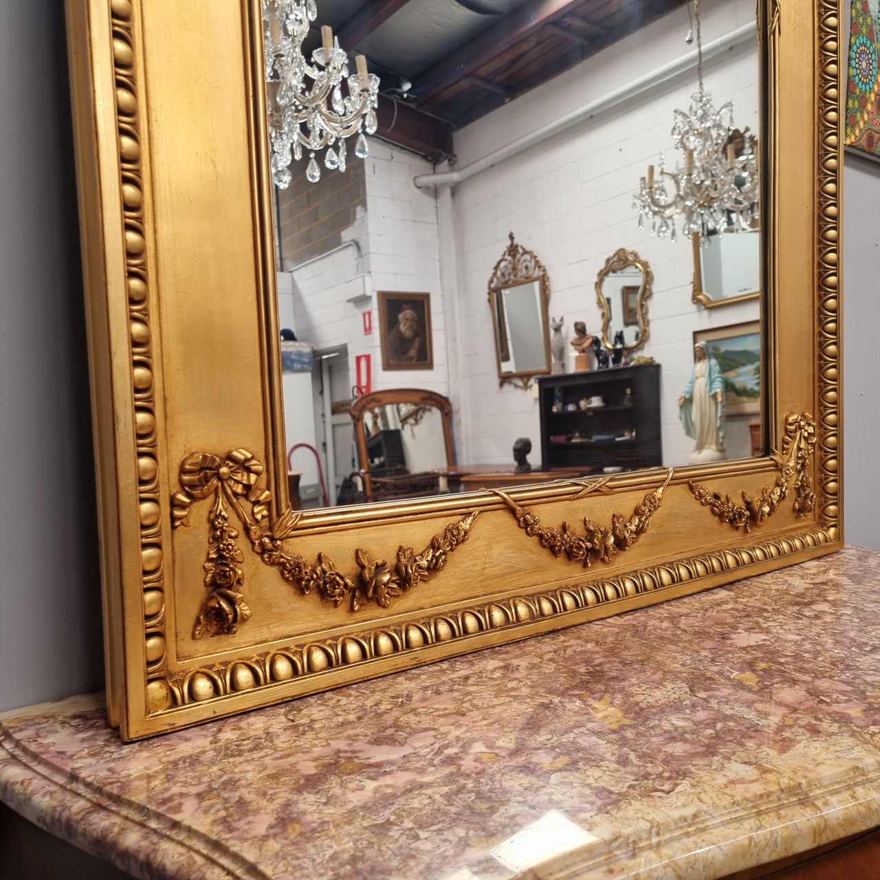 Stunning Vintage French floral gilt framed overmantel mirror. It has been sourced from France and is in good original detailed condition.