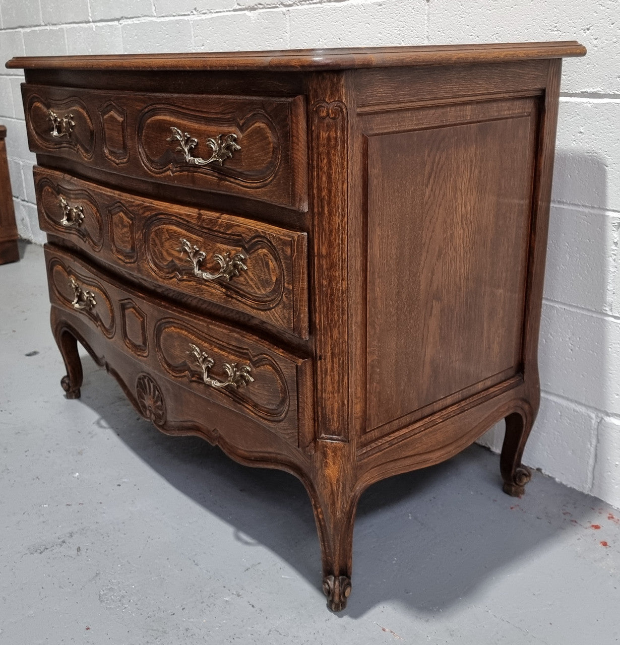 Lovely French nicely carved chest of 3 drawers with a parquetry top, with decorative handles and lovely carving. In good detailed condition.