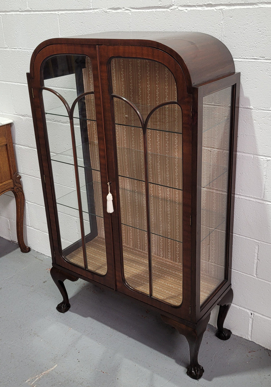 Chippendale style Walnut display cabinet of pleasing narrow portrions. It is in good original condition and comes with three shelves.
