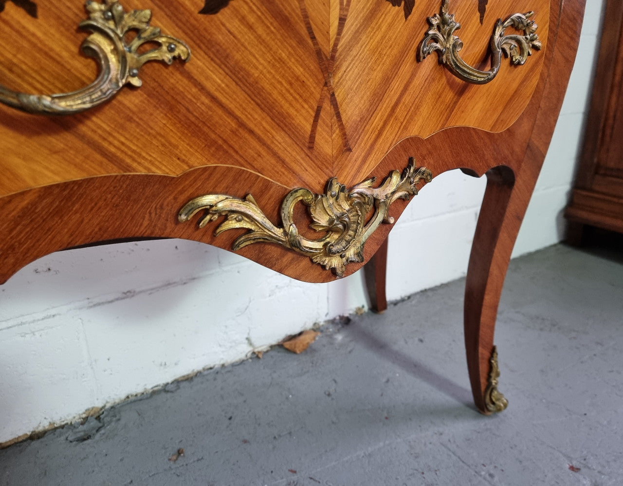 Charming petite French Louis XV style commode featuring two drawers, marquetry inlay, ormolu trim and marble Top. In good original detailed condition. Circa: 1930’s.