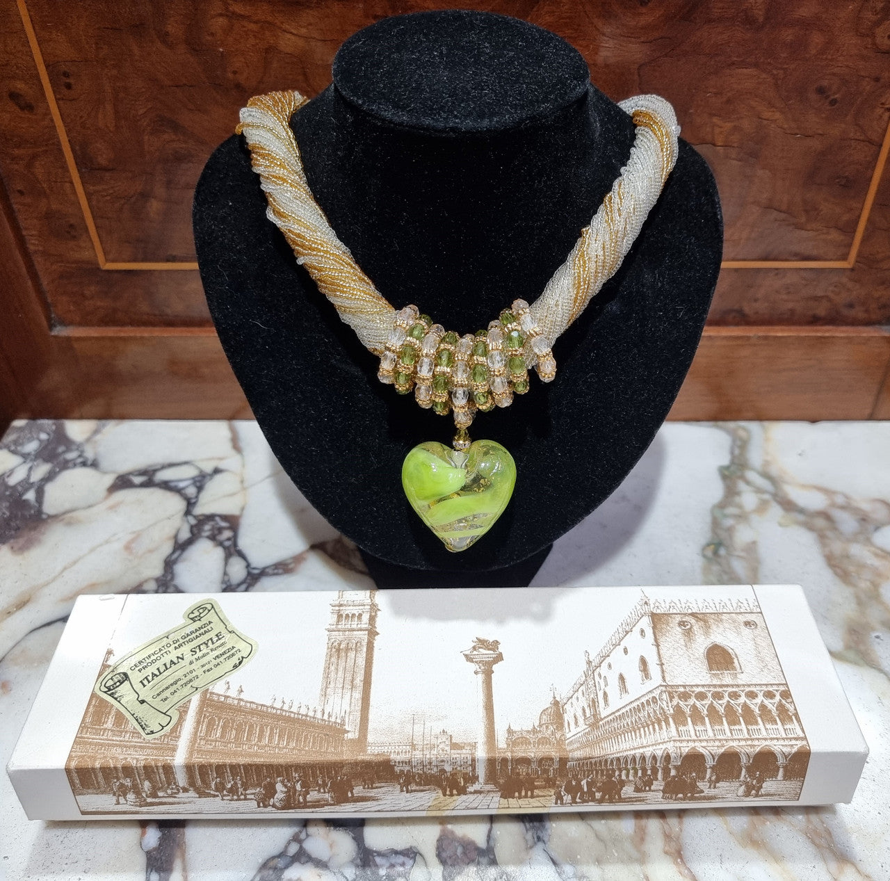 Hand Made Murano glass multi string small glass beads with medium glass beads and a large puff heart in neutral and green shades with gold. In original box.