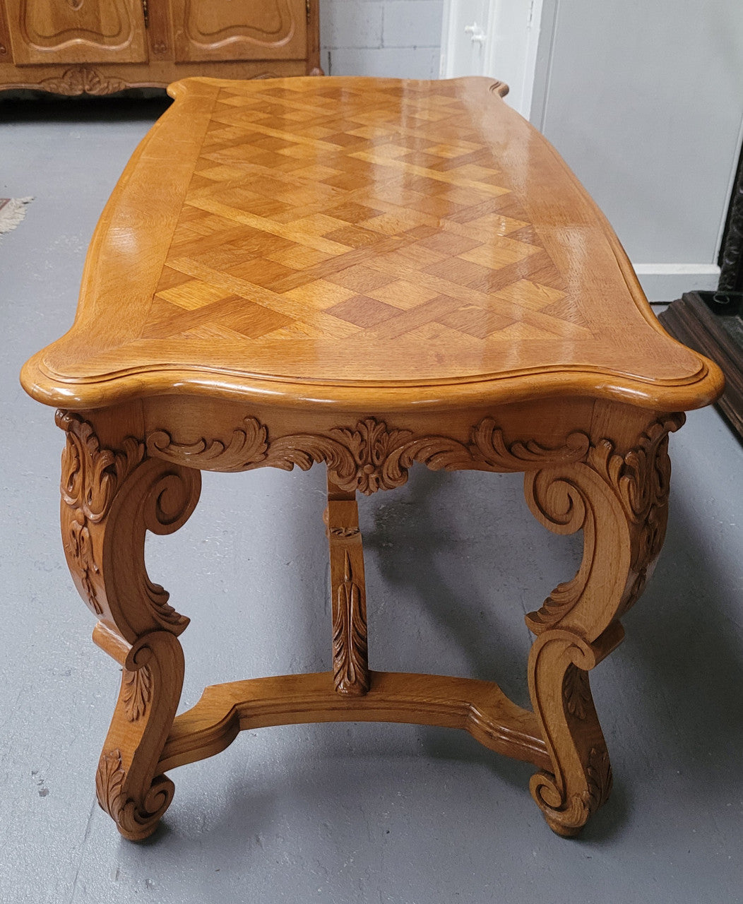 French Oak parquetry top coffee table with decorative carved base. It is in good original detailed condition.