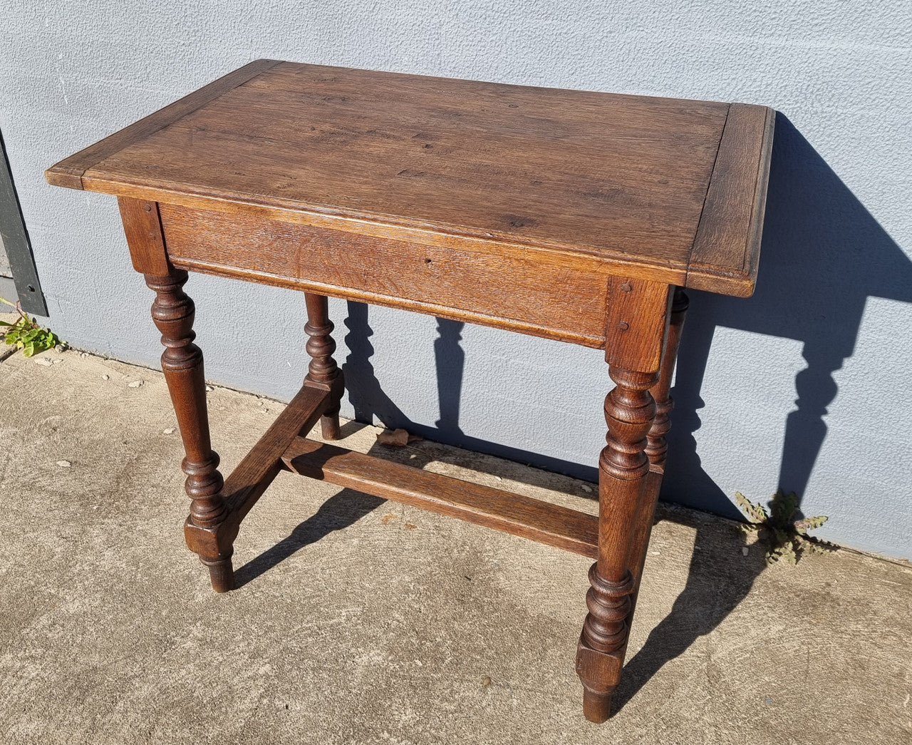 Lovely Oak Tudor style rope edge sideboard with leadlight centre door, three drawers and two solid cupboards. In good original condition.