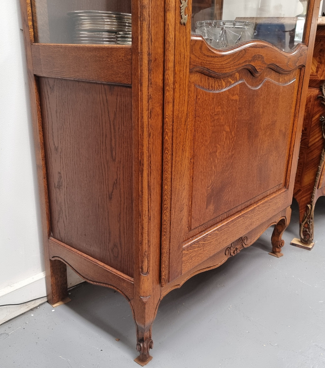 French Oak Louis XV Style Vitrine with two fixed glass shelves at the top and two fixed wooden shelves at the base for added storage. It has been sourced from France and in good original detailed condition.