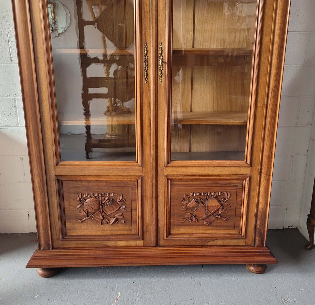 Stunning French Walnut Henry II style two door bookcase with four fully adjustable shelves. The lock on the door is functional and has a key. It is in good original detailed condition.