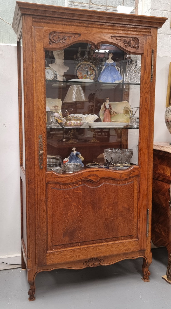 French Oak Louis XV Style Vitrine with two fixed glass shelves at the top and two fixed wooden shelves at the base for added storage. It has been sourced from France and in good original detailed condition.