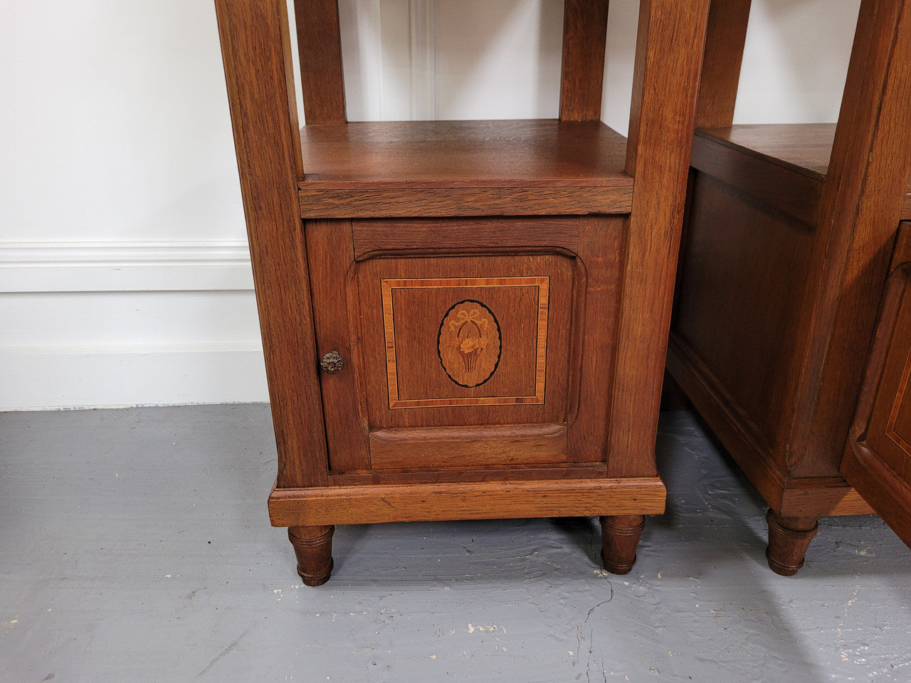 Pair of Antique French Oak Louis XVI style marble top bedside cabinets. They have decorative inlay and have been sourced from France. They are in good original detailed condition.
