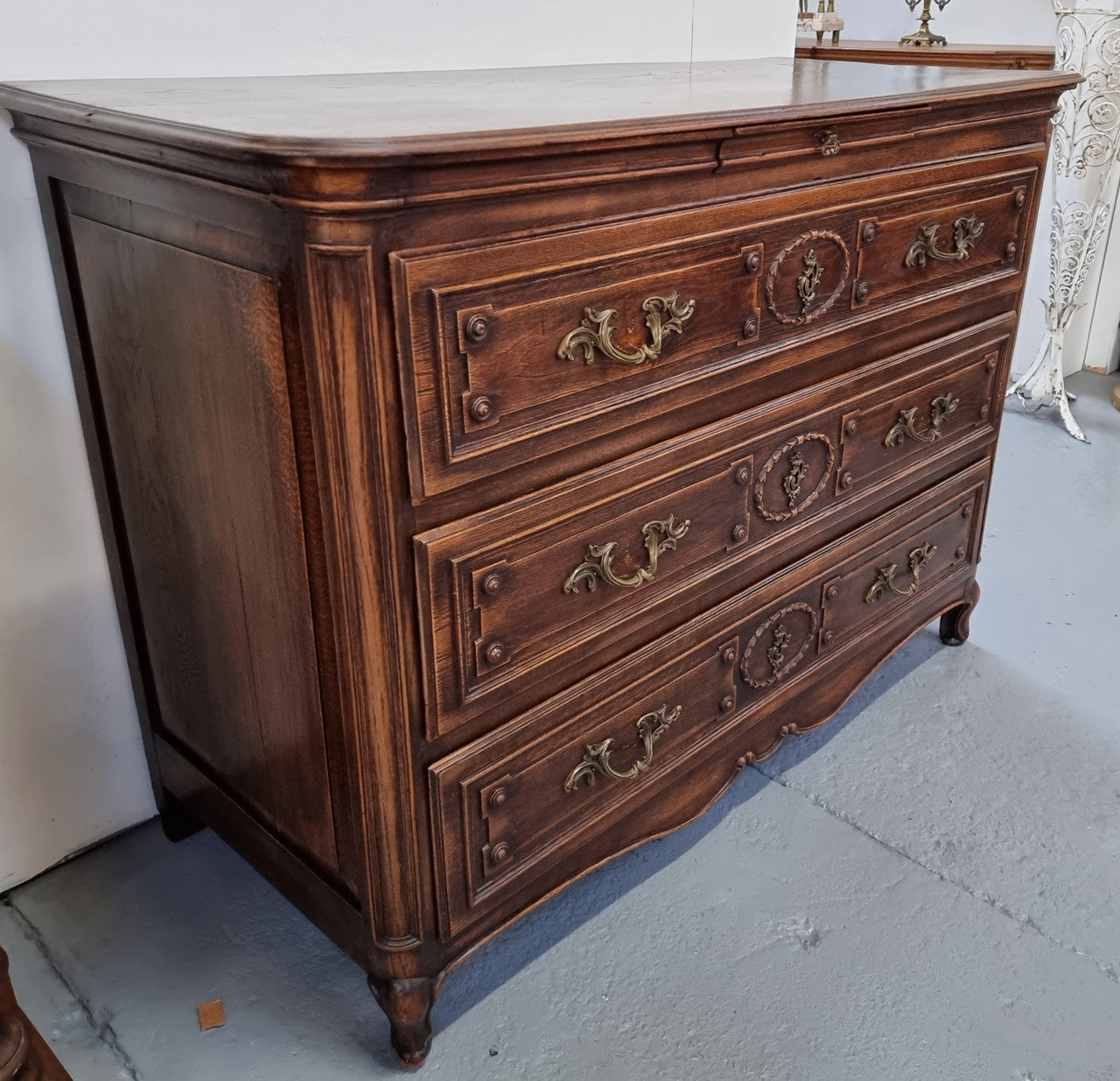 Early 19th century carved Oak three-drawer commode. Beautiful handles and has a small hidden drawer at the top. In good original detailed condition. Please note keys are not included.