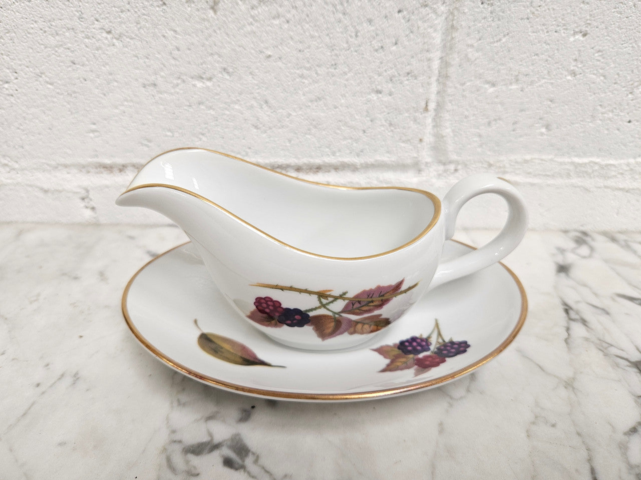 Royal Worcester "Evesham" Pattern small Jug and Saucer. Good Condition no cracks or chips. Please see photos as they form part of the description.