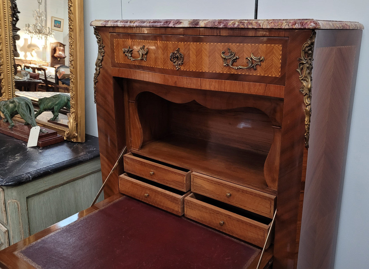 Walnut Louis XV style marble top abbattant with beautiful parquetry inlay and ormolu mounts. It has plenty of storage space with four large drawers and four smaller internal drawers. Beautiful drop down desk with a leather insert. In very good original detailed condition.