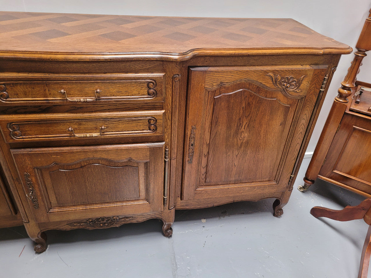 French Oak Louis XV style three door, two drawer, parquetry top sideboard. It has been sourced from France and is in good restored condition.