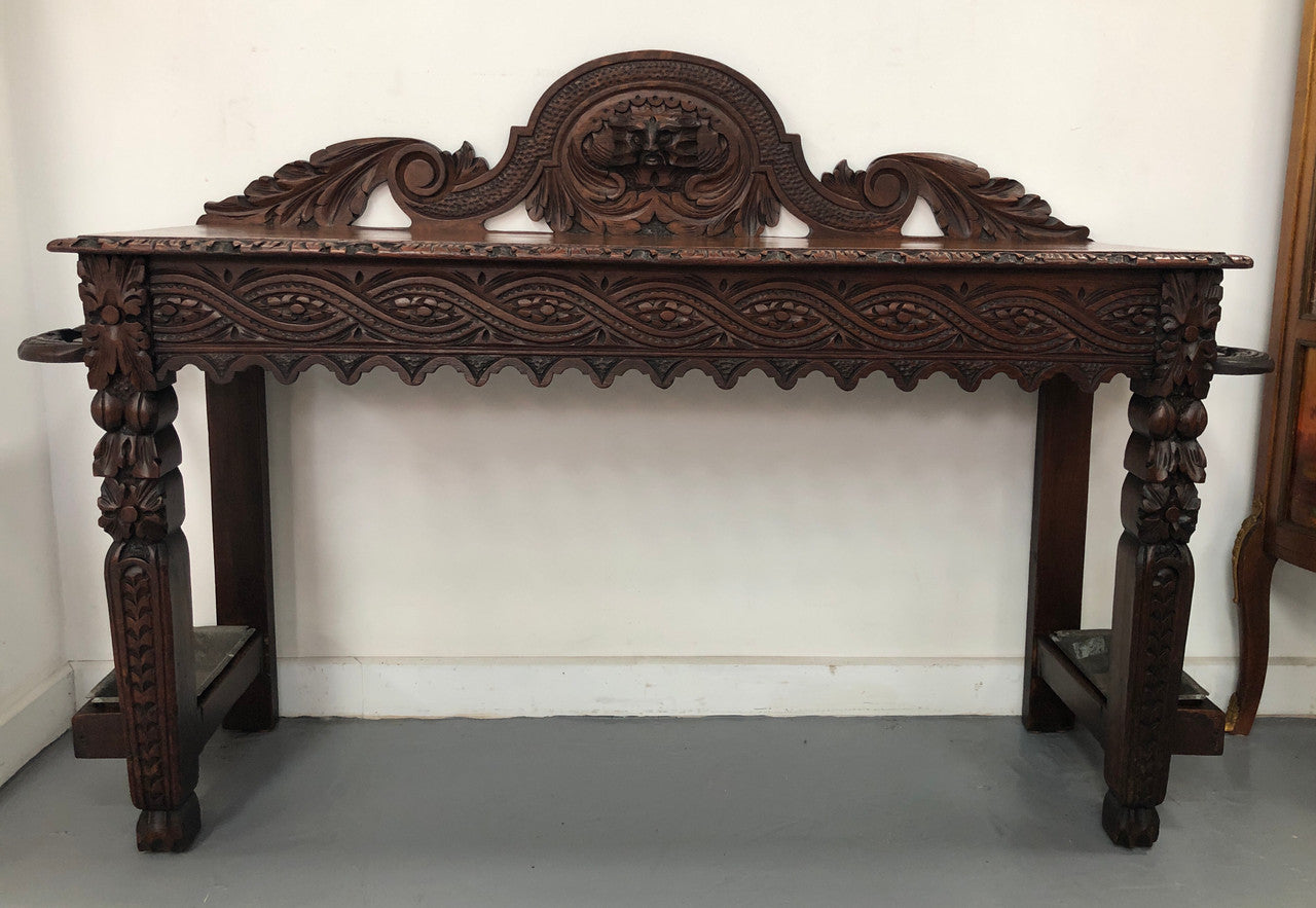 Superb 19th Century Gothic style hall/console table. It has umbrella and walking stick holders on both sides. In good original detailed condition.