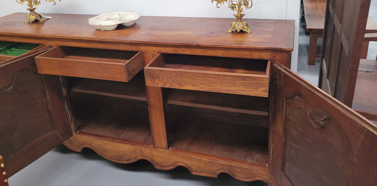 Early 19th Century Louis XV style Fruitwood three door sideboard. It has three hidden internal drawers and one of them has green valet and small sections for cutlery. It is in good restored condition.