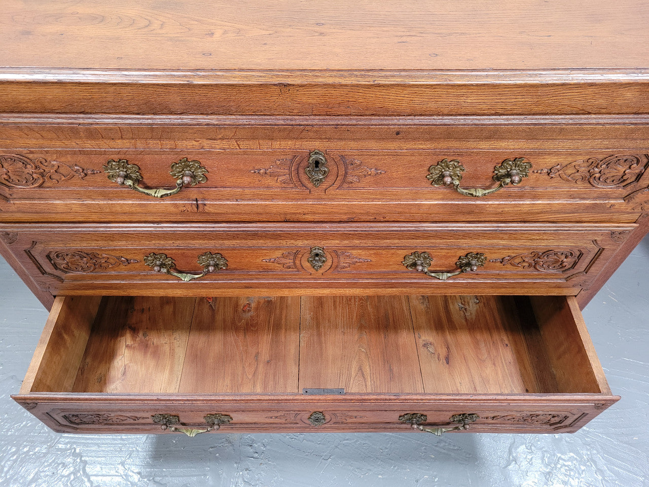 French Louis 15th style large three drawer chest featuring carved drawers. It has been sourced from France and is in good original detailed condition.
