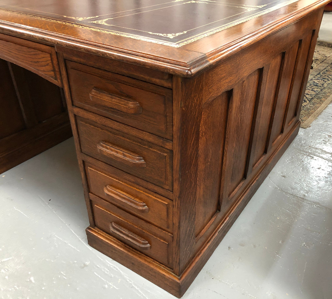Lovely large English oak partners desk, with a beautiful burgundy tooled leather top. Plenty of storage space, both sides have 9 functioning drawers. It is in very good condition.