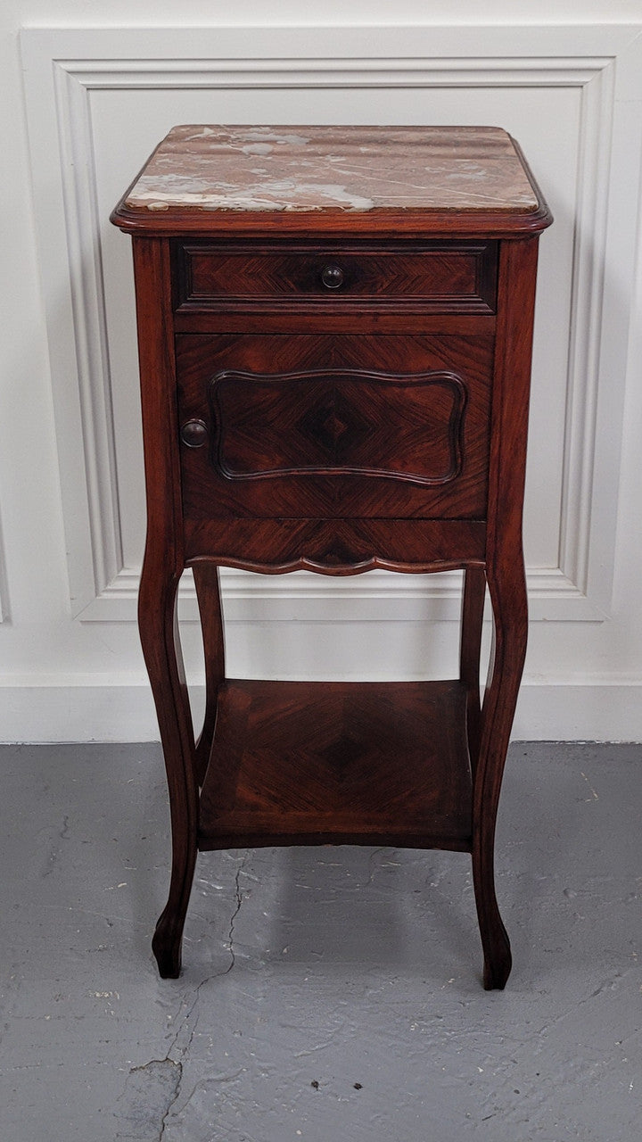French Rosewood inset marble top single bedside cabinet with one drawer and one cupboard on elegant legs. Would also make a practical and stunning table lamp. It is in good original detailed condition.