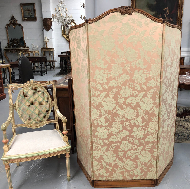 An antique French Walnut louis XVI style 3 fold screen/divider. Upholstered with beautiful pink silk brocade fabric. The fabric is in good overall condition with some minor wear and tear which is expected for its age. It has been sourced directly from France. Please view photos as they help to form part of the description and condition.
