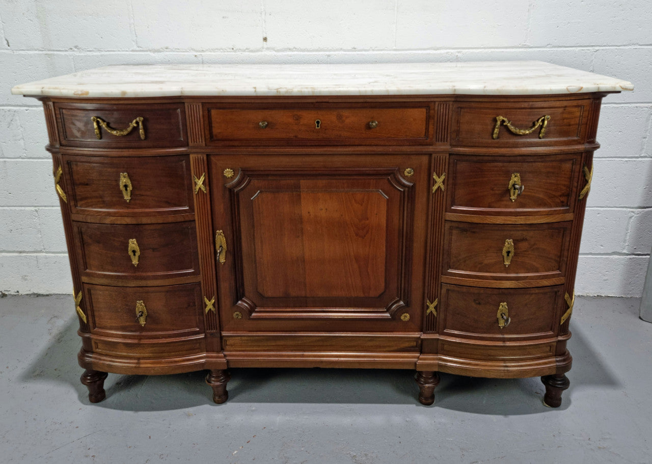 Fabulous French Walnut Louis XVI style cupboard, with a lovely marble top and nine drawers. There is also a cupboard and beautiful ormolu mounts. It is in good original detailed condition.