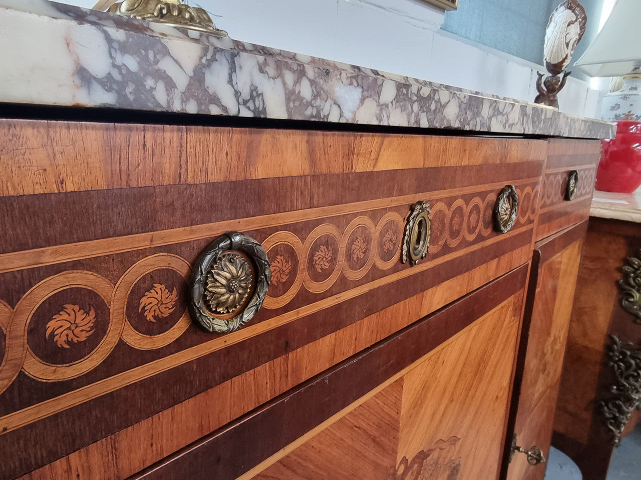 A high quality 19th Century French marquetry inlaid Kingwood marble top credenza. It has an attractive solid marble top and decorative marquetry inlay throughout. It has plenty of storage space with three drawers and three doors. It has been sourced from France and is in good original detailed condition.