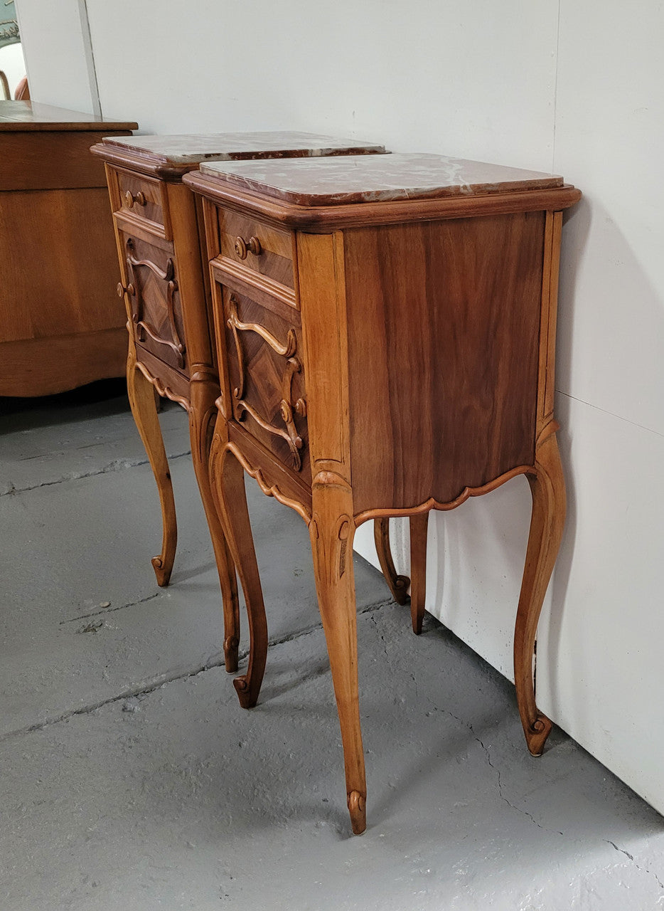 Pair French Walnut Louis XV style Bedside Cabinets with inset rouge carrera marble tops and parquetry inlay. Consisting of one drawer and one cupboard on very elegant legs. Circa: 1900's.