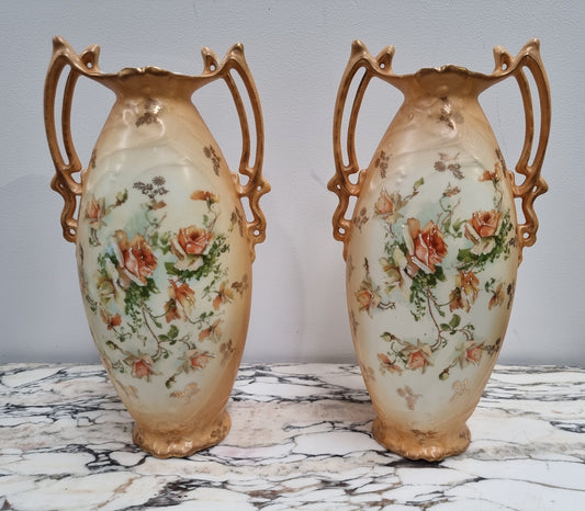 Decorative Pair of Art Nouveau Vases decorated with hand finished roses in muted tones. Gilt highlights. Impressed numbers to base. In good original condition, please view photos as they help form part of the description.