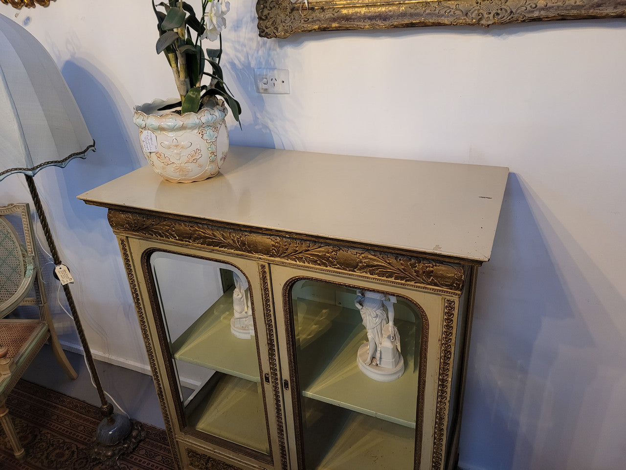19th Century painted and gilt two door vitrine. Has one adjustable shelf and two drawers. In good original detailed condition.